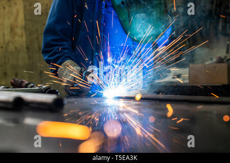 Welder in his workshop welding metal Stock Photo