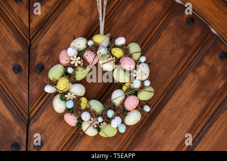 Easter egg wreath hangs on the door. Stock Photo