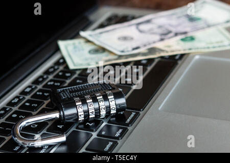 Locker and dollars on a laptop. Security online concept Stock Photo