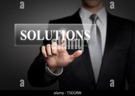 business, technology, internet, network concept - businessman in suit presses virtual touchscreen interface button - english word SOLUTIONS Stock Photo