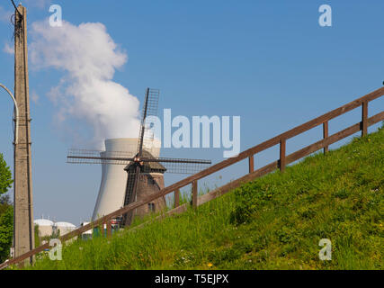 Doel, Belgium - April 21, 2019: Nearly abandoned Village Doel, small, old windmill in front of the Doel nuclear power plant Stock Photo