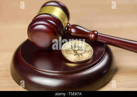 Bitcoin Regulation. BTC crypto coin and gavel on a desk. Stock Photo