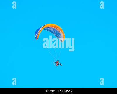 One man practicing extreme sport with paraglider with motor Stock Photo