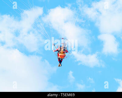 One man practicing extreme sport with paraglider with motor Stock Photo