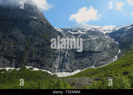 Glacier and falls in mountains. Olden, Norway Stock Photo
