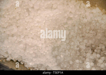 hail collects in a gutter after a hail storm, Photographed in Haifa, Israel in March Stock Photo