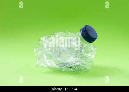 Disposable waste plastic bottle on green background Stock Photo