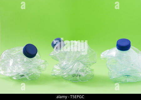 Disposable waste plastic bottle on green background Stock Photo