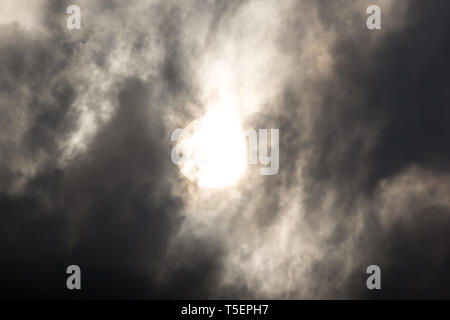 the sun hide behind grey cloud on evening Stock Photo