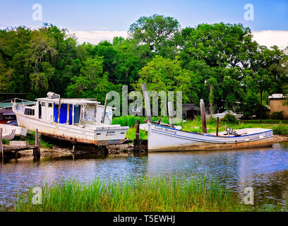 Two oyster boats, Diana and God’s Blessing, are docked along the bank in Bayou La Batre, Alabama. Stock Photo