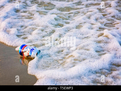 A Natural Light beer can lays on the beach, April 19, 2019, in Dauphin Island, Alabama. Most disposable cans like this are made from aluminum. Stock Photo