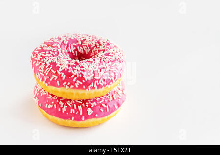 Two donuts with pink icing on a white background. Stock Photo