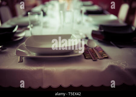 elegant table setting with decoration for dinner in regular home Stock Photo
