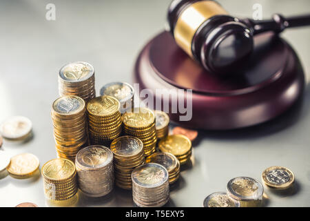 Towers with euro coins and justice hammer in the background. Stock Photo