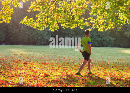 Back view of a man doing morning exercise in the Green park of London Stock Photo