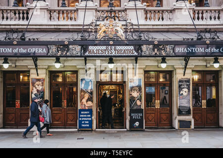 London, UK - April 13, 2019: People walking by Her Majesty Theatre, a theatre in West End of London whose name changes depending on the gender of the  Stock Photo