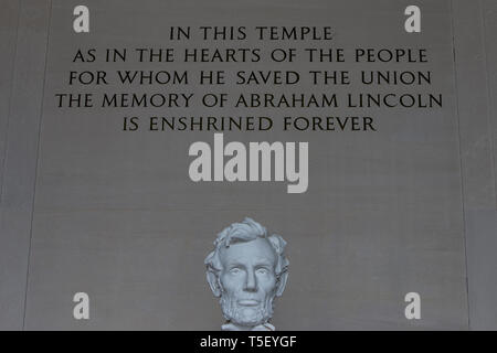 The words ' In this Temple as in the hearts of the people for whom he saved the Union the memory of Abraham Lincoln is enshrined forever' above the sculpture of a seated Abraham Lincoln inside the Lincoln Memorial in Washington. Dedicated in 1922, the American national monument is a major tourist attraction and since the 1930s a symbolic center focused on race relations. Many famous speeches have been performed here, including Rev. Martin Luther King Jr's 'I have a Dream.' Stock Photo