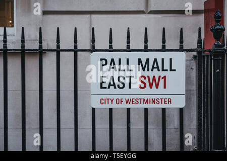 London, UK - April 13, 2019: Street name sign on a fence in Pall Mall East, City of Westminster, a borough that occupies much of the central area of L Stock Photo