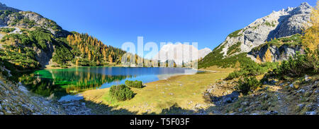 The fantastically situated Seebensee in tyrolean alps with the western rock wall of the Zugspitze in falltime Stock Photo