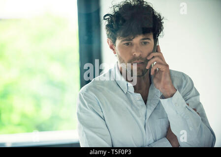 Businessman talking on smartphone Stock Photo