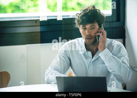 Businessman talking on smartphone Stock Photo