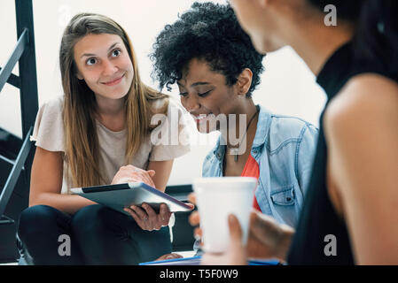 Businesswomen using digital tablet in office Stock Photo