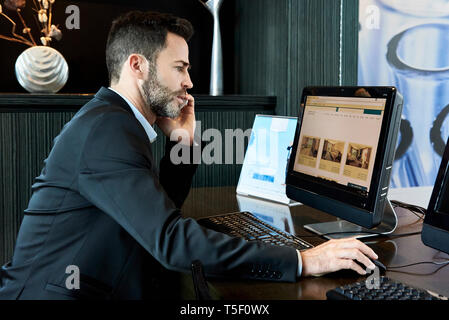 Businessman working on computer in hotel Stock Photo