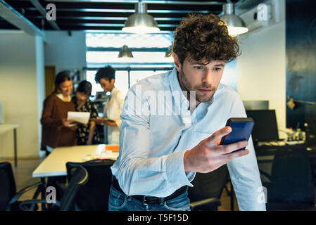 Businessman using smartphone Stock Photo