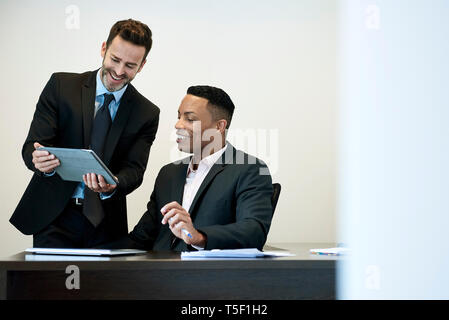 Businessmen using a digital tablet in office Stock Photo