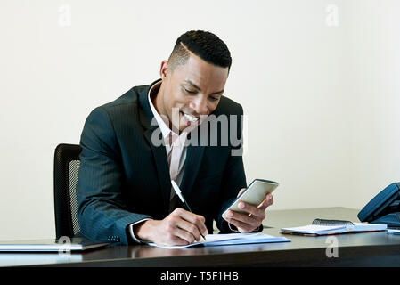 Businessman checking a document on his desk Stock Photo