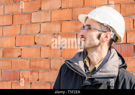 Portrait of a young civil engineer wearing hardhat on construction site Stock Photo