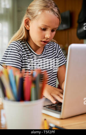 Girl working on her homework Stock Photo - Alamy