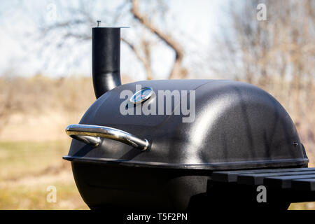 Black big barrel grill in the garden Stock Photo