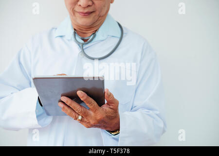 Doctor working on tablet computer Stock Photo