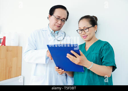 Doctor and nurse reading document Stock Photo