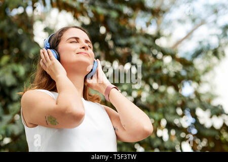 Woman enjoying good music Stock Photo