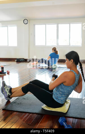 Women doing side twists with balls Stock Photo