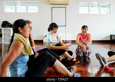 Talking young women in gym Stock Photo