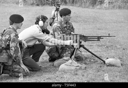 Prince Charles, ear defenders in place, prepares to fire a burst from a GPMG (General Purpose Machine Gun) at Aliwal Barracks, Tidworth, Hampshire. Prince Charles, who is Colonel-in-Chief of the Cheshire Regiment, visited the 1st Battalion at the Barracks accompanied by Lady Diana Spencer. Stock Photo