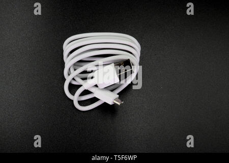 Cable connector micro-USB to USB on black background. High resolution image gallery. Stock Photo