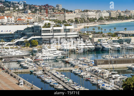 CANNES, FRANCE - APRIL 2019: View overlooking the marina in Cannes with the bay in the background. Stock Photo