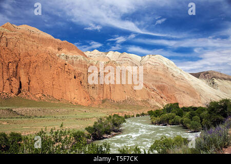 Landscape with river and red mountains. Summer time. Kyrgyzstan. Suusamyr valley Kekemeren River Stock Photo