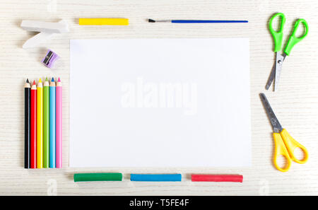 Vertical composition of post its, eraser, crayons and scissors on blue  surface with copy space Stock Photo by Wavebreakmedia