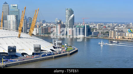 Aerial view urban landscape beside River Thames  modern riverside building development on waterfront & London Canary Wharf cityscape skyline London UK Stock Photo