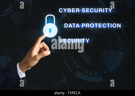 Businessman pressing padlock icon on dark background. Data security concept Stock Photo