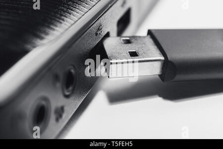close up of black usb pen drive and the side of black laptop Stock Photo