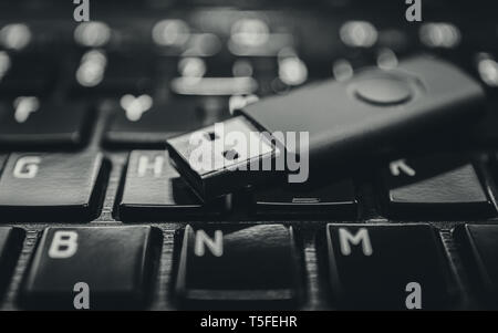 USB pen drive on black laptop keyboard Stock Photo