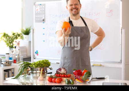 Man Blogger Holding Orange Cooking Vegetables Stock Photo