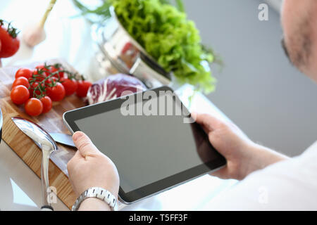 Chef Tablet Showing Organic Vegetable Recipe Stock Photo