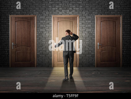 Thoughtful businessman opening door. Concept of choice Stock Photo
